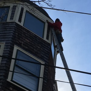 guy working on gutters in Melrose, MA