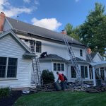 Front of home with ladders leading to the roof